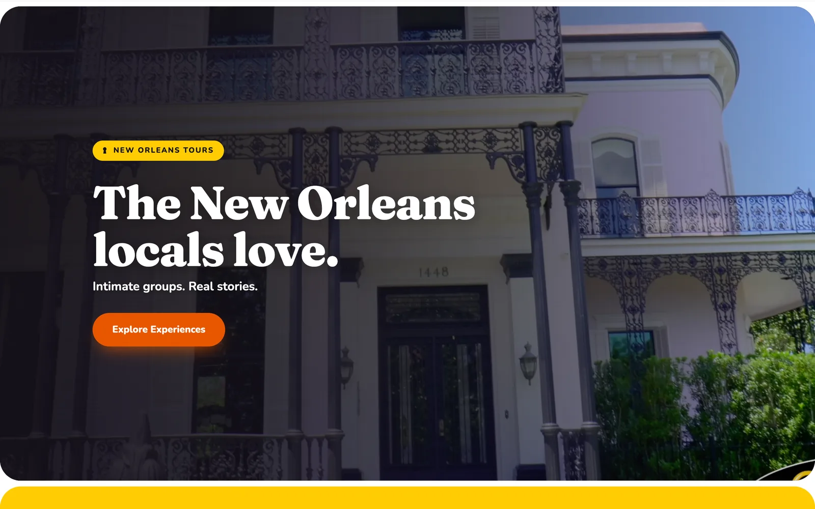 Home page of a city tour website on a laptop: a balcony with iron lacework, a serif headline and an orange button