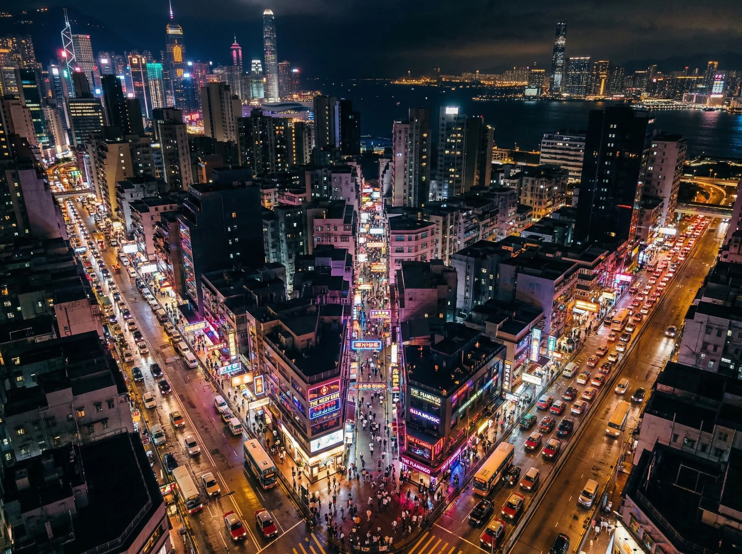 Neon-lit city street with bar crawl guests hopping between venues