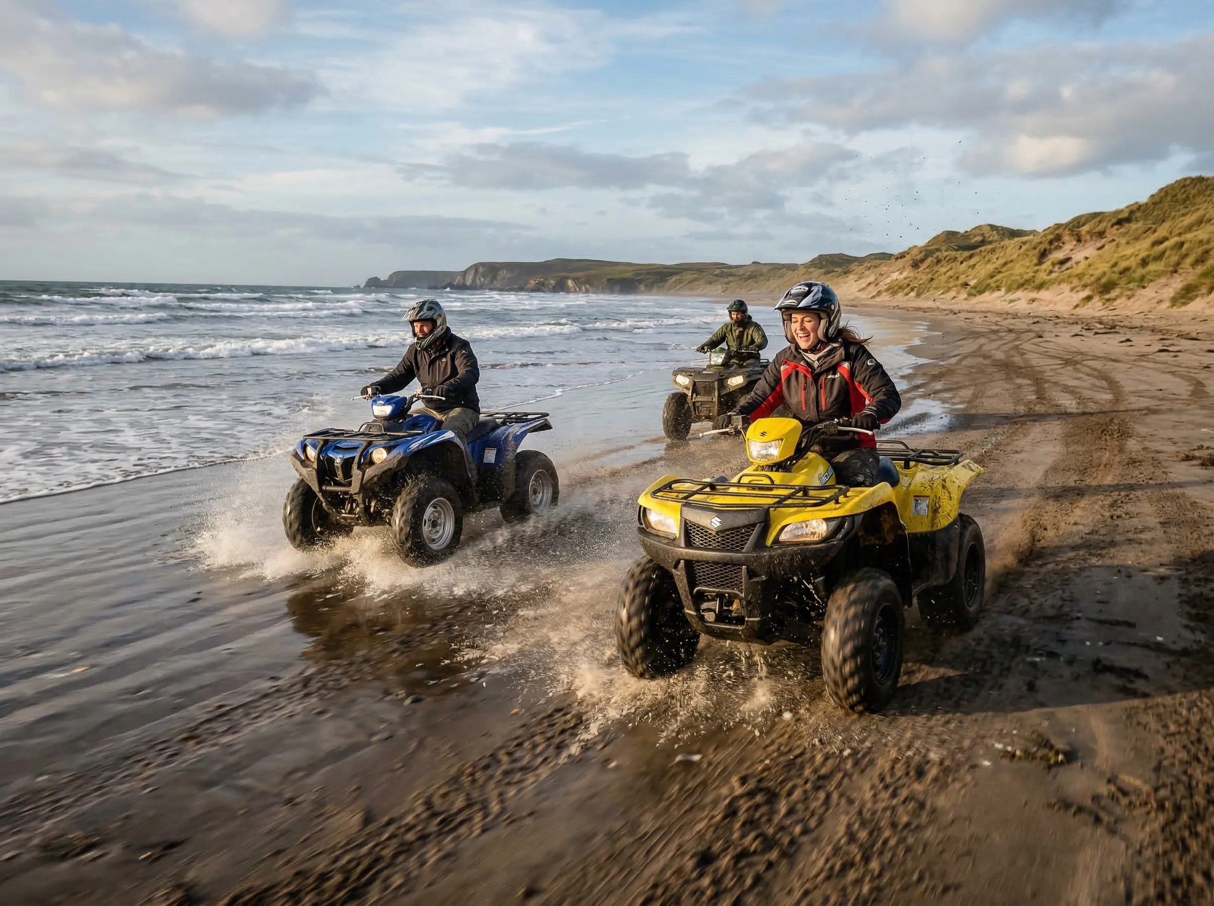 ATVs riding along a remote beach at low tide