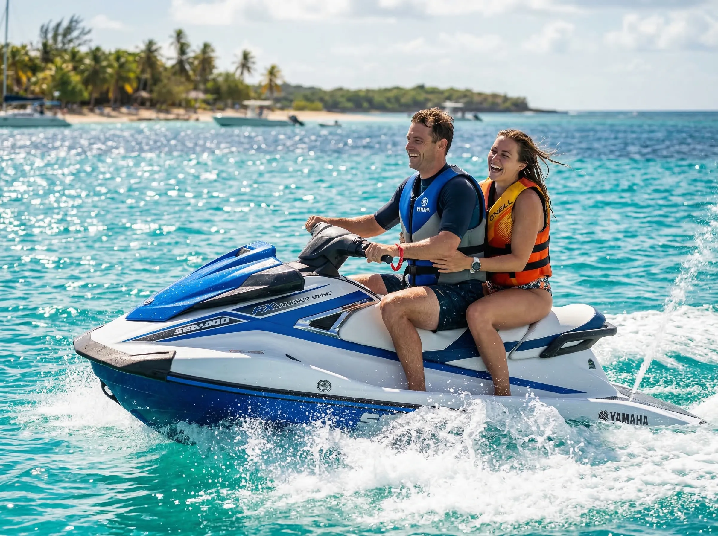 Couple riding a jet ski together across turquoise Caribbean water