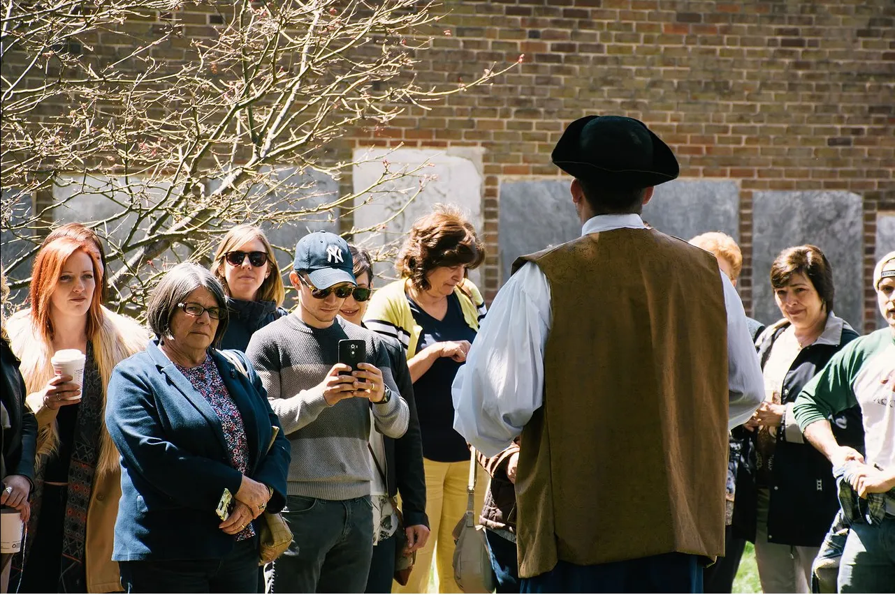 A costumed Philadelphia guide leading a group of travelers