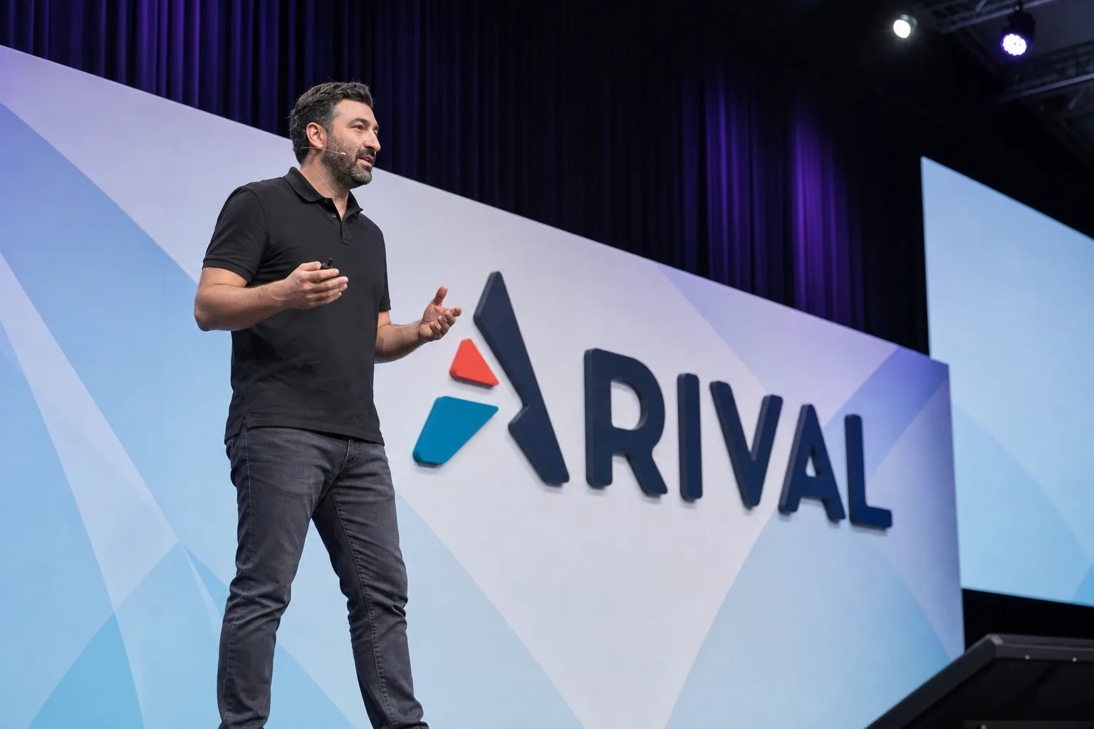 Vitaliy Levit speaking on stage at the Arival conference